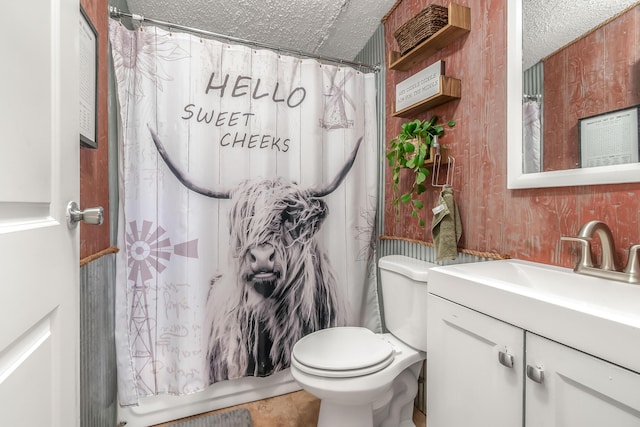 full bath with toilet, a textured ceiling, and vanity