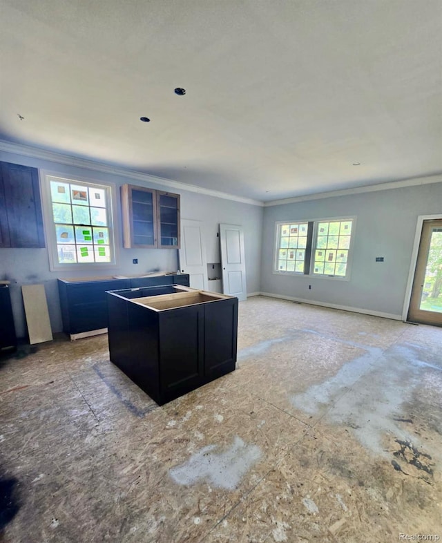 8475 Stout Ave, Warren, MI 48093 - kitchen with crown molding, dark cabinetry, and a center island