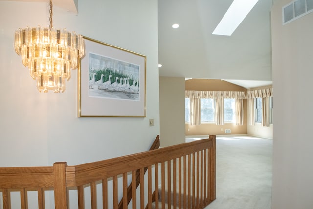 hall with an upstairs landing, visible vents, recessed lighting, a chandelier, and carpet floors