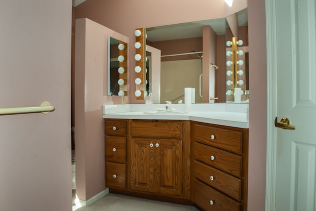 bathroom featuring walk in shower and vanity