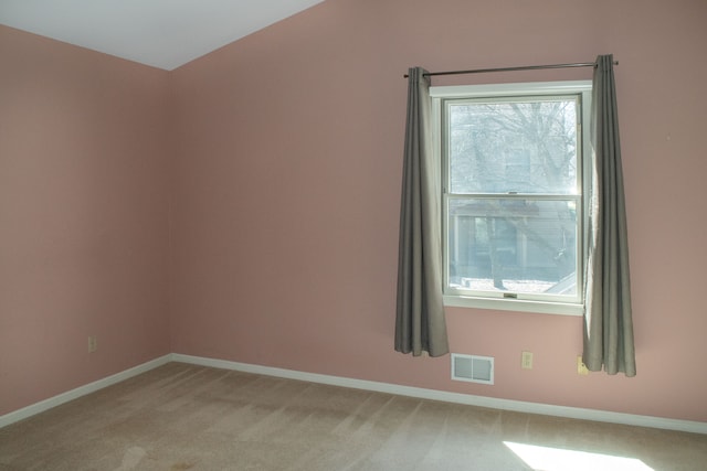 unfurnished room featuring light colored carpet, visible vents, and baseboards