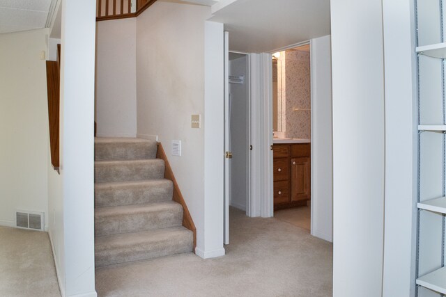 stairs featuring carpet flooring, baseboards, and visible vents