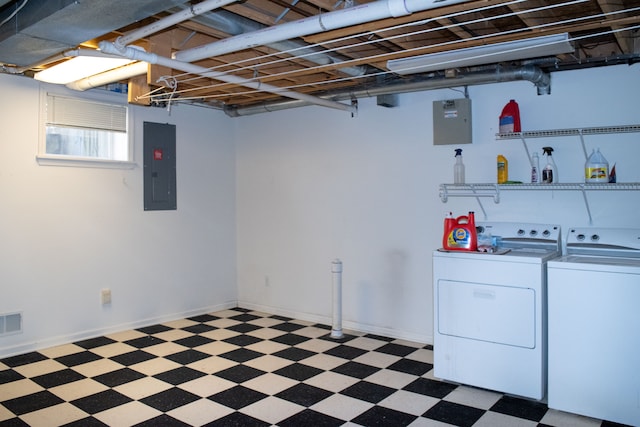 below grade area with electric panel, tile patterned floors, independent washer and dryer, and visible vents