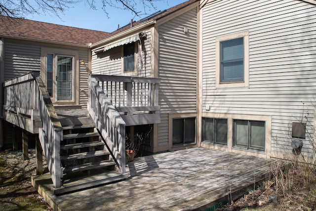 back of property featuring a deck and stairs