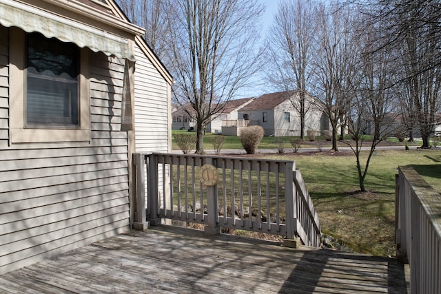 deck featuring a yard and a residential view