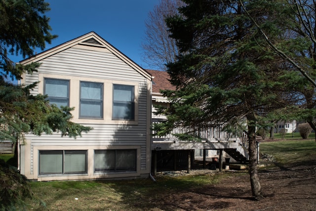 view of side of property featuring stairway