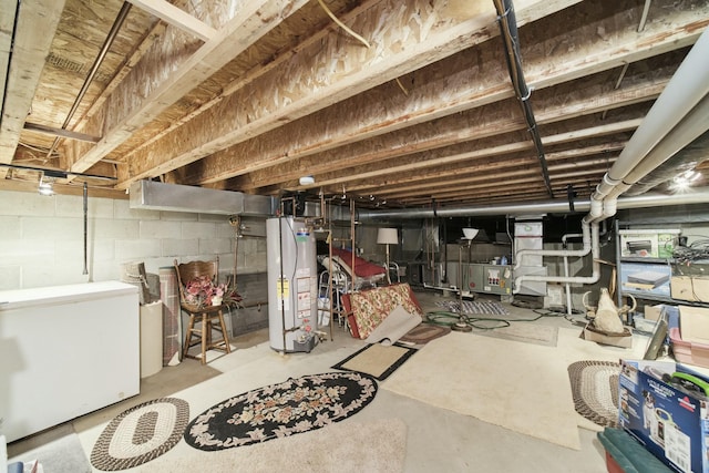 unfinished basement featuring refrigerator and gas water heater