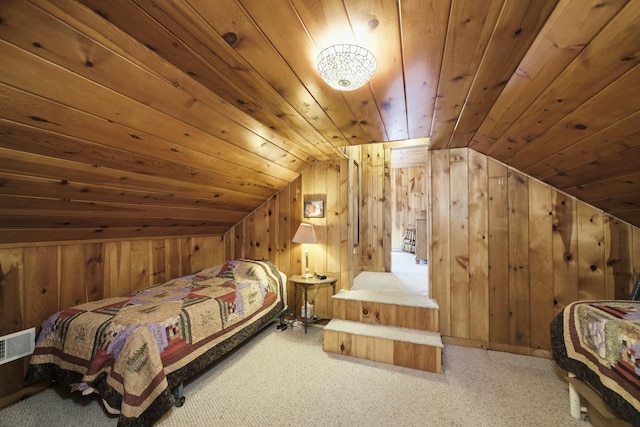 bedroom with wooden walls, carpet floors, visible vents, lofted ceiling, and wood ceiling
