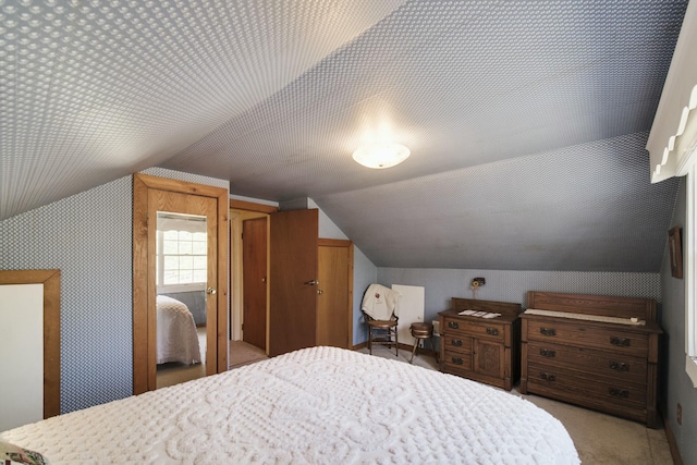 carpeted bedroom with vaulted ceiling
