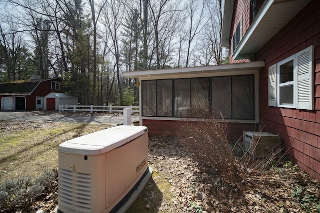 exterior space with a sunroom, central air condition unit, and fence