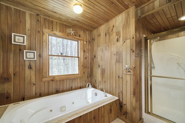 bathroom with a shower stall, a jetted tub, wooden ceiling, and wooden walls