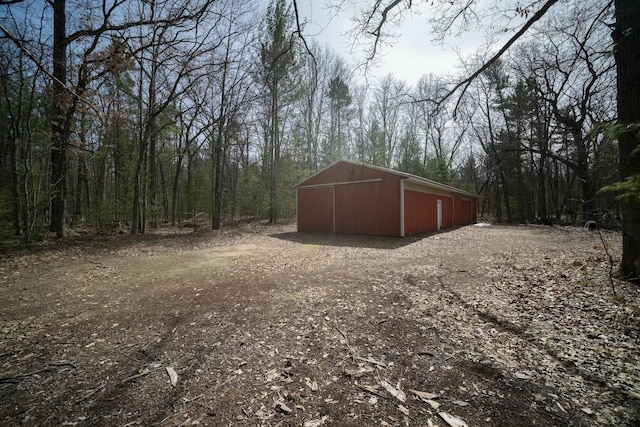 view of pole building featuring a forest view