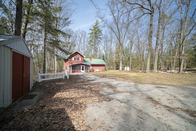exterior space with driveway and fence