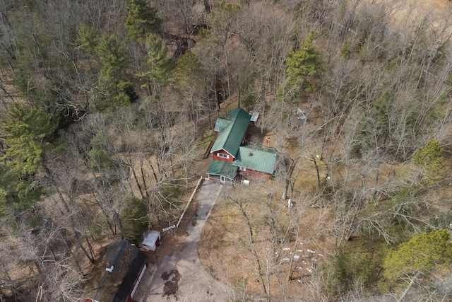 drone / aerial view with a wooded view