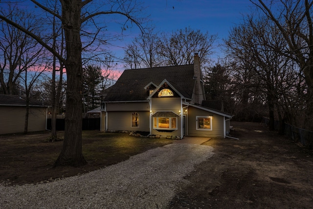 3628 Ford Ave, Jackson, MI 49203 - view of front of property with driveway, a chimney, and fence