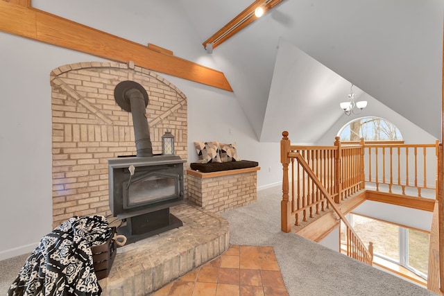 3628 Ford Ave, Jackson, MI 49203 - living room with a notable chandelier, lofted ceiling, a wood stove, and carpet
