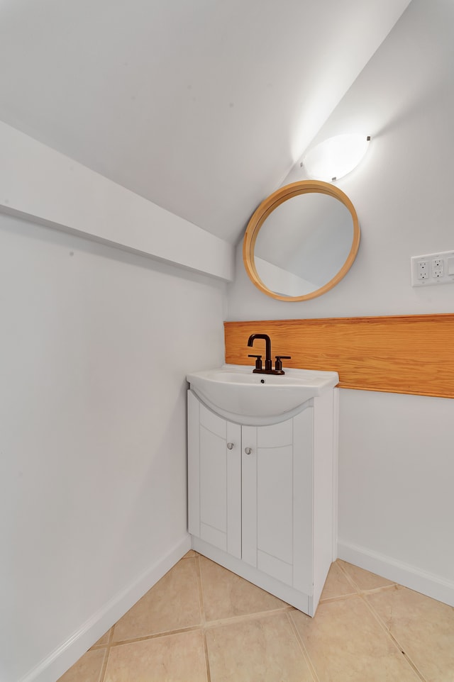 3628 Ford Ave, Jackson, MI 49203 - bathroom featuring lofted ceiling, baseboards, tile patterned flooring, and vanity