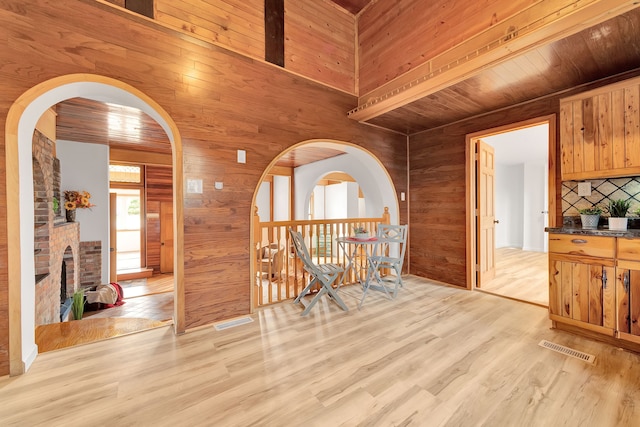 3628 Ford Ave, Jackson, MI 49203 - interior space with wooden walls, visible vents, and light wood-style floors