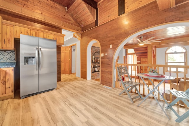 3628 Ford Ave, Jackson, MI 49203 - kitchen featuring wood walls, arched walkways, wood ceiling, stainless steel fridge, and ceiling fan