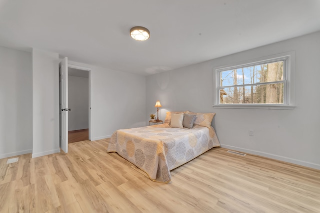 3628 Ford Ave, Jackson, MI 49203 - bedroom featuring baseboards, wood finished floors, and visible vents