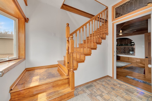 3628 Ford Ave, Jackson, MI 49203 - staircase featuring baseboards, visible vents, ceiling fan, and brick floor