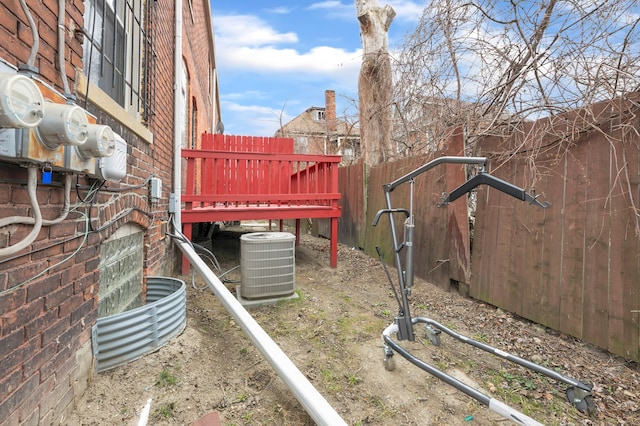 view of yard with fence and central air condition unit
