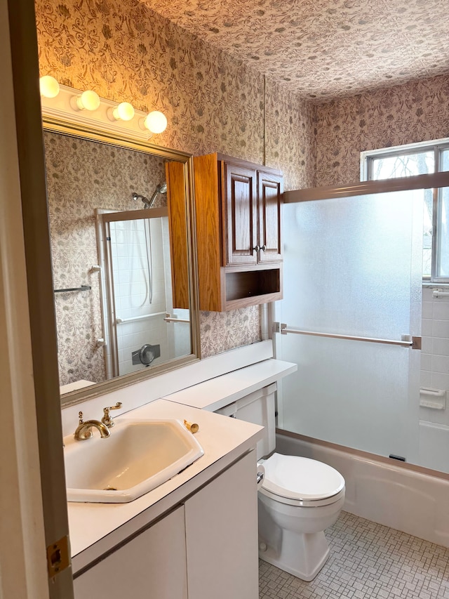 5959 Alan Dr Unit 57, Brighton, MI 48116 - bathroom with combined bath / shower with glass door, toilet, vanity, wallpapered walls, and tile patterned floors