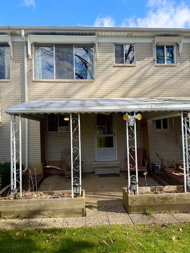 5959 Alan Dr Unit 57, Brighton, MI 48116 - view of front facade with a patio and brick siding