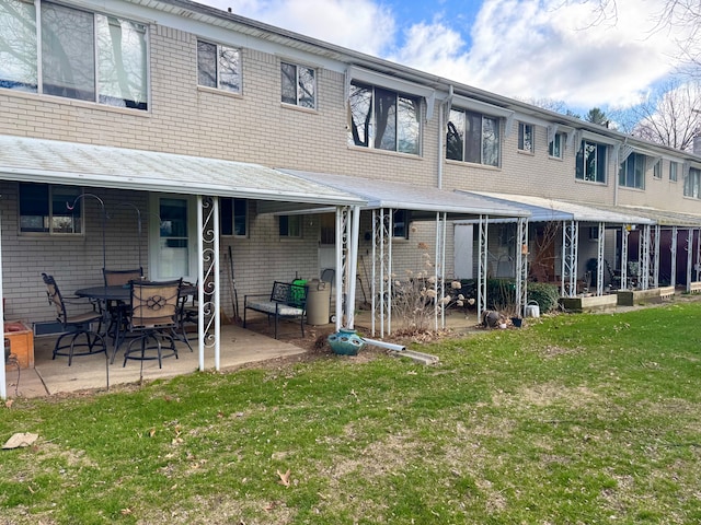 5959 Alan Dr Unit 57, Brighton, MI 48116 - back of property featuring a patio and a yard