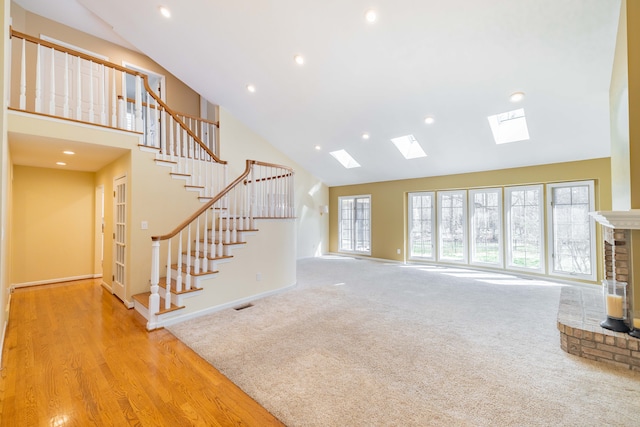 7837 Oak River Dr, Grosse Ile, MI 48138 - unfurnished living room with visible vents, recessed lighting, stairway, a skylight, and high vaulted ceiling