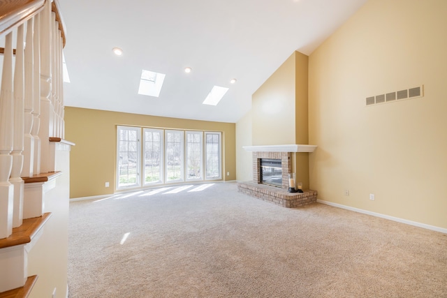 7837 Oak River Dr, Grosse Ile, MI 48138 - unfurnished living room with a fireplace, carpet floors, visible vents, a skylight, and high vaulted ceiling