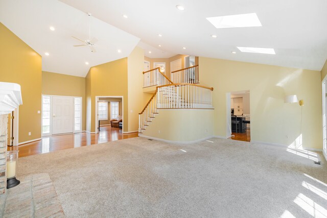 7837 Oak River Dr, Grosse Ile, MI 48138 - unfurnished living room featuring high vaulted ceiling, baseboards, carpet, and stairway