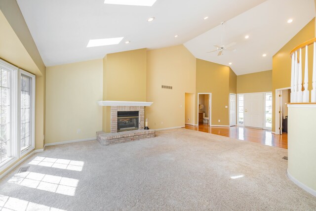7837 Oak River Dr, Grosse Ile, MI 48138 - unfurnished living room with baseboards, a fireplace, visible vents, high vaulted ceiling, and carpet