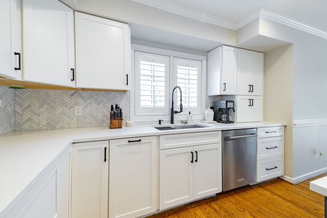 7837 Oak River Dr, Grosse Ile, MI 48138 - kitchen with ornamental molding, white cabinets, decorative backsplash, dishwasher, and a sink