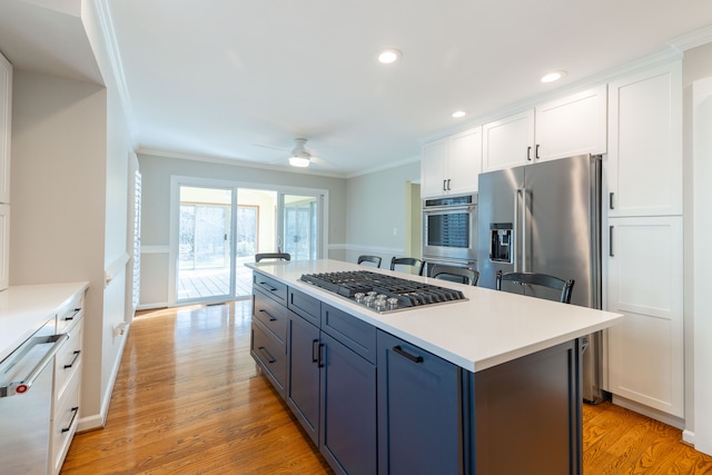 7837 Oak River Dr, Grosse Ile, MI 48138 - kitchen with white cabinetry, ornamental molding, and appliances with stainless steel finishes