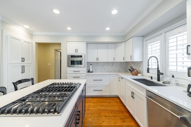 7837 Oak River Dr, Grosse Ile, MI 48138 - kitchen with crown molding, appliances with stainless steel finishes, a sink, and white cabinets