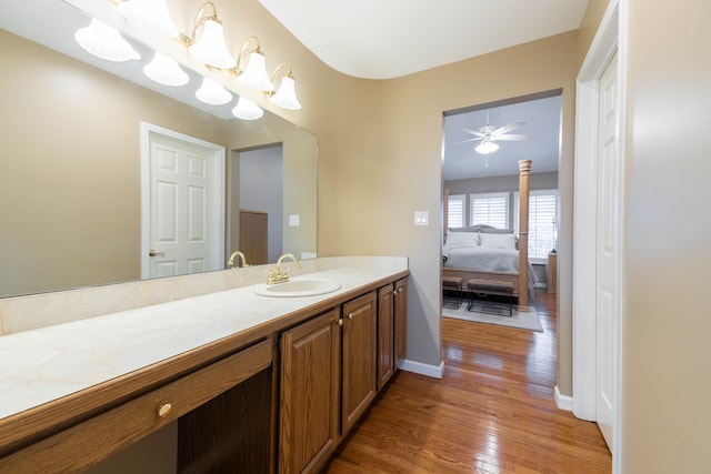 7837 Oak River Dr, Grosse Ile, MI 48138 - bathroom featuring vanity, baseboards, hardwood / wood-style floors, and ceiling fan