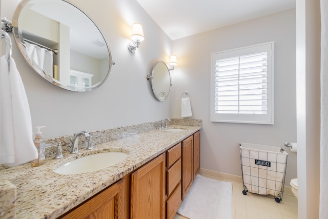 7837 Oak River Dr, Grosse Ile, MI 48138 - bathroom featuring toilet, double vanity, a sink, and baseboards