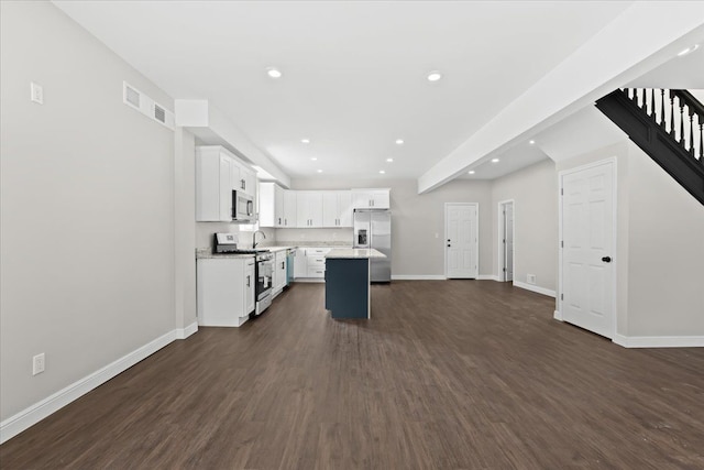 592 Leicester, Detroit, MI 48202 - kitchen featuring appliances with stainless steel finishes, white cabinetry, a kitchen island, dark wood-style flooring, and recessed lighting