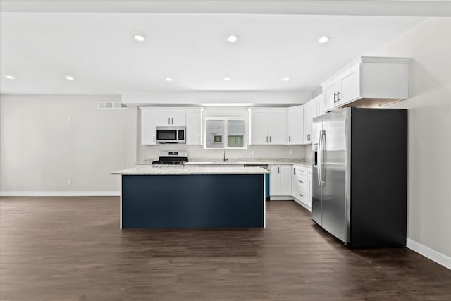 592 Leicester, Detroit, MI 48202 - kitchen featuring appliances with stainless steel finishes, baseboards, dark wood finished floors, a kitchen island, and recessed lighting