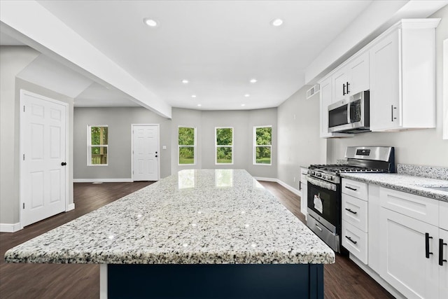 592 Leicester, Detroit, MI 48202 - kitchen with stainless steel appliances, a kitchen island, baseboards, light stone counters, and recessed lighting