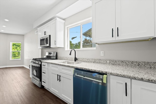 592 Leicester, Detroit, MI 48202 - kitchen featuring appliances with stainless steel finishes, a sink, dark wood finished floors, white cabinetry, and light stone counters