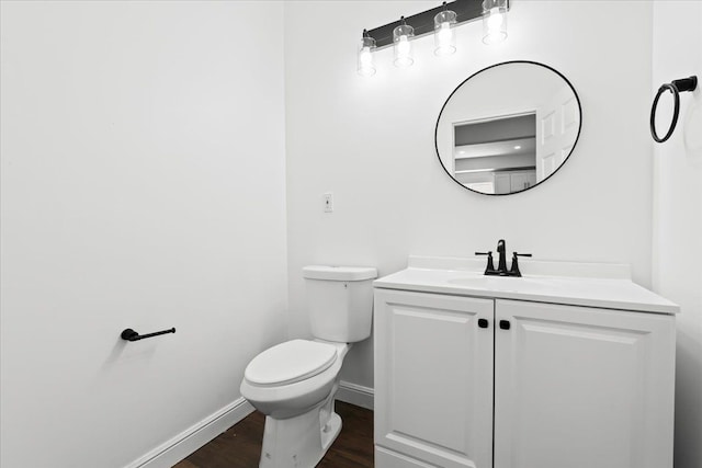 592 Leicester, Detroit, MI 48202 - half bathroom featuring toilet, baseboards, wood finished floors, and vanity