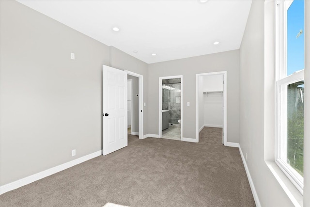 592 Leicester, Detroit, MI 48202 - unfurnished bedroom featuring carpet flooring, a walk in closet, baseboards, a closet, and ensuite bath