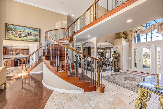 2434 Pebble Beach Dr, Oakland, MI 48363 - entrance foyer with a towering ceiling, baseboards, crown molding, stairs, and arched walkways