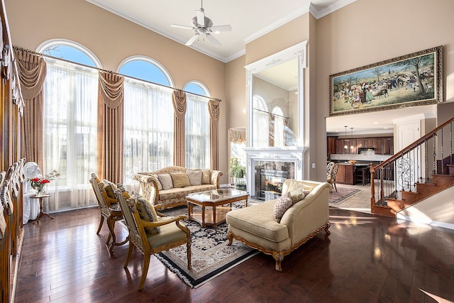 2434 Pebble Beach Dr, Oakland, MI 48363 - living room featuring crown molding, hardwood / wood-style floors, a high end fireplace, and a ceiling fan