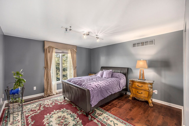 2434 Pebble Beach Dr, Oakland, MI 48363 - bedroom featuring visible vents, baseboards, rail lighting, and dark wood finished floors