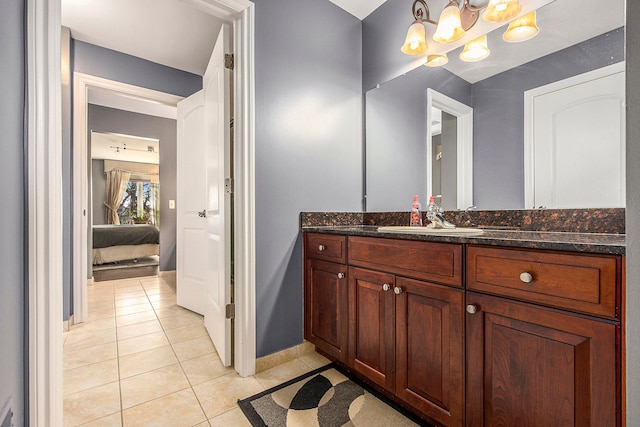 2434 Pebble Beach Dr, Oakland, MI 48363 - bathroom featuring connected bathroom, vanity, a chandelier, tile patterned floors, and baseboards