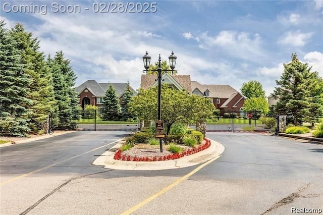 2434 Pebble Beach Dr, Oakland, MI 48363 - view of road with street lights, a gated entry, and a gate
