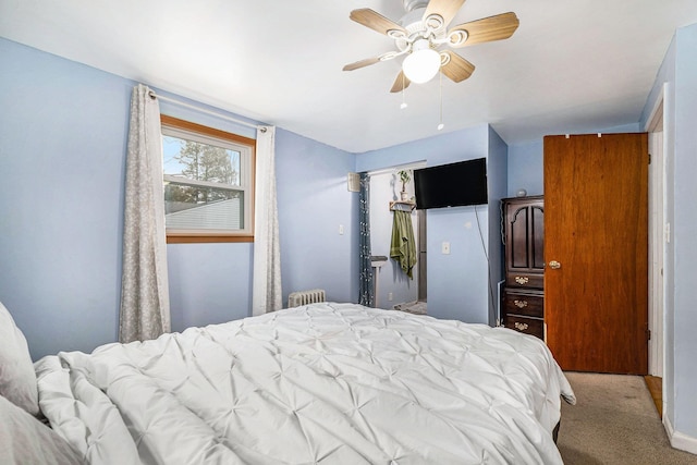 bedroom featuring radiator heating unit, ceiling fan, and carpet